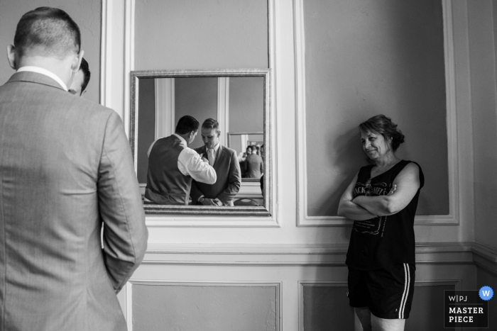 Photo by: <a href="https://www.wpja.com/contests/2019-v17/best-wedding-photographers/2565092">Earl McCoy - Columbia Heights Minnesota</a> Greysolon Ballroom wedding venue photos | Mom watching Groom getting help in the mirror