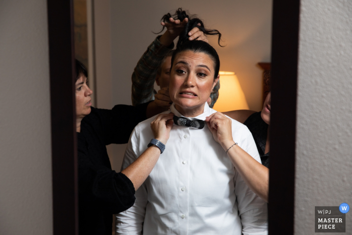 Photo by: <a href="https://www.wpja.com/contests/2019-v17/best-wedding-photographers/2565093">Earl McCoy - Columbia Heights Minnesota</a> Wedding pictures from a Hotel in Minneapolis - Friends helping with tie and hair in the mirror