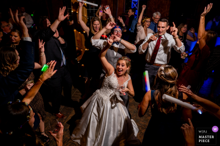 Photo by: <a href="https://www.wpja.com/contests/2019-v17/best-wedding-photographers/2565176">Brittany Diliberto - Arlington Virginia</a> Virginia wedding photography at Bluemont Vineyard | The bride is surrounded by her friends on the dance floor.