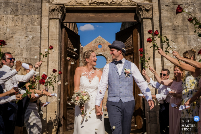 Photo by: <a href="https://www.wpja.com/contests/2019-v18/best-wedding-photographers/2565402">Andrea Sampoli - Siena Siena</a> Wedding photography from the San galgano Abbey, Agriturismo San Galgano, Siena | Confetti after the cerimony with roses bridge
