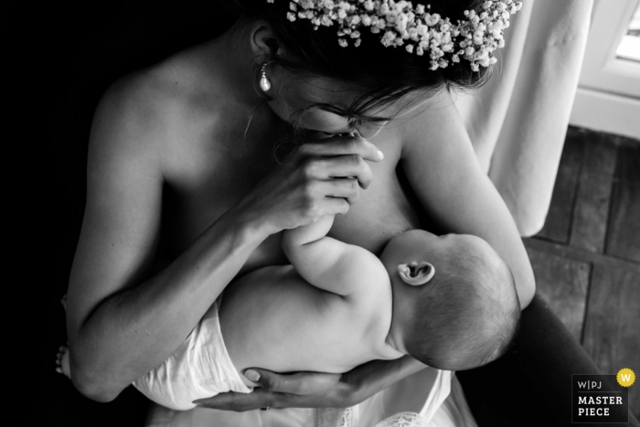 Photo by: <a href="https://www.wpja.com/contests/2019-v18/best-wedding-photographers/2565734">Chrystel Echavidre - Saubrigues </a> Nouvelle-Aquitaine reception venue photo of a suspended moment... bride but also mother breastfeeding her baby