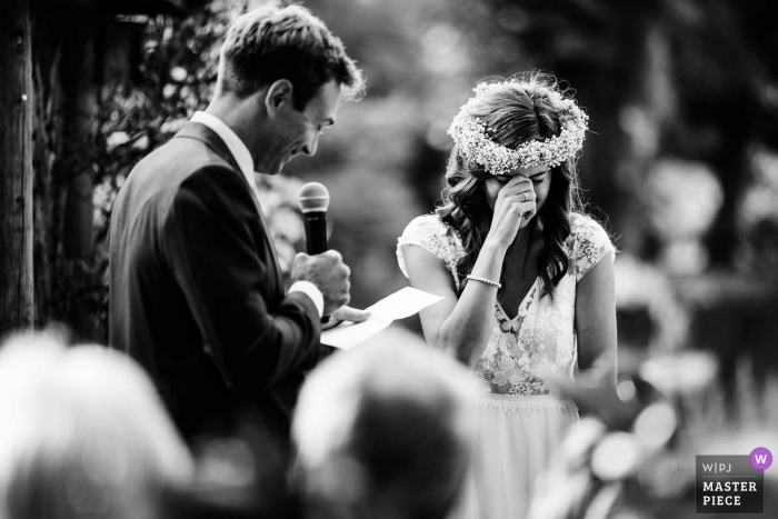 Photo by: <a href="https://www.wpja.com/contests/2019-v18/best-wedding-photographers/2565851">Aaron Storry - Kettering Northamptonshire</a> Wedding Photography at Chippenham Park, United Kingdom | Sweet bride crying during the grooms speech at an outdoor ceremony at Chippenham Park