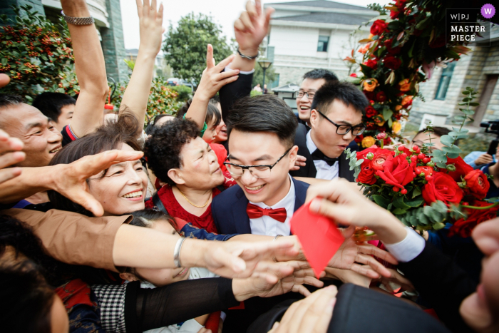 Photo by: <a href="https://www.wpja.com/contests/2019-v18/best-wedding-photographers/2566622">Di Liu - Hangzhou </a> Ningbo, China Chinese traditional customs - Red envelopes and gate crashers in photo