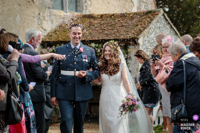 Photo by: <a href="https://www.wpja.com/contests/2019-v18/best-wedding-photographers/2566789">Catherine Hill - Canterbury Kent</a> Petham Church, Kent, UK wedding picture | The newlyweds are showered with confetti and look so happy