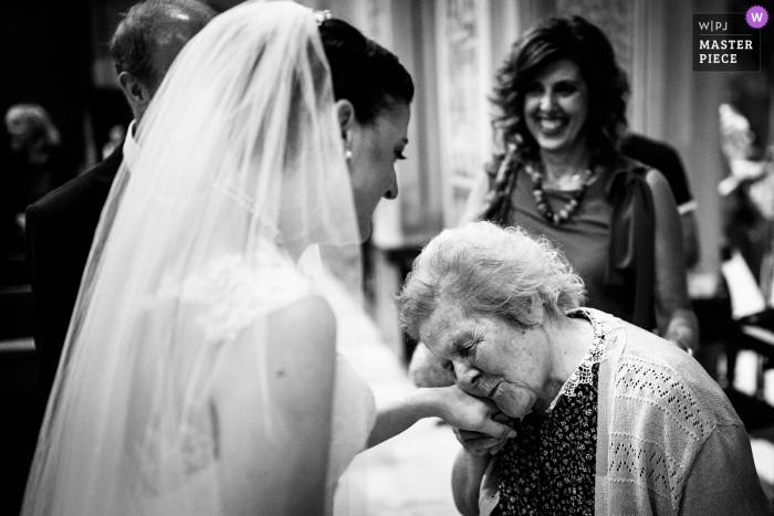Photo by: <a href="https://www.wpja.com/contests/2019-v18/best-wedding-photographers/2566838">Giorgia Gaggero - Cairo Montenotte Savona</a> Church of Cairo Montenotte (SV) wedding picture | Grandma kissing the bride after the ceremony