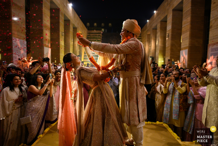 The garland exchange ceremony truly depicts the personality of a couple Mumbai wedding photographer: "The garland exchange ceremony truly depicts the personality of a couple and as a photographer I love to capture these moments between moments!"