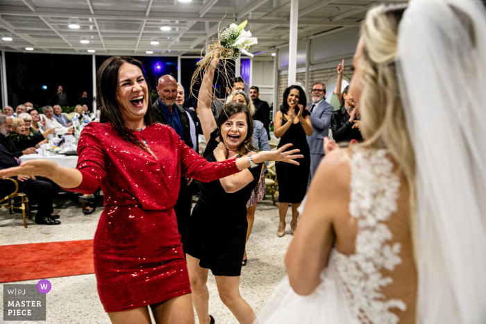 Photo by: <a href="https://www.wpja.com/contests/2019-v18/best-wedding-photographers/2567470">Orçun Yalçın - Ankara Ankara</a> Wedding venue photography at the Özak Hotel, Ayvalık, Balıkesir | Bridesmaids are celebrating with the bride after the bouquet toss