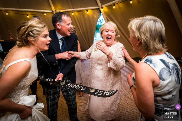 Photo by: <a href="https://www.wpja.com/contests/2019-v18/best-wedding-photographers/2567644">Ashley Coombes - Stirling Stirlingshire</a> Photo from a Marquee tent wedding at home in Gartocharn Stirlingshire | Doing shots across the generations