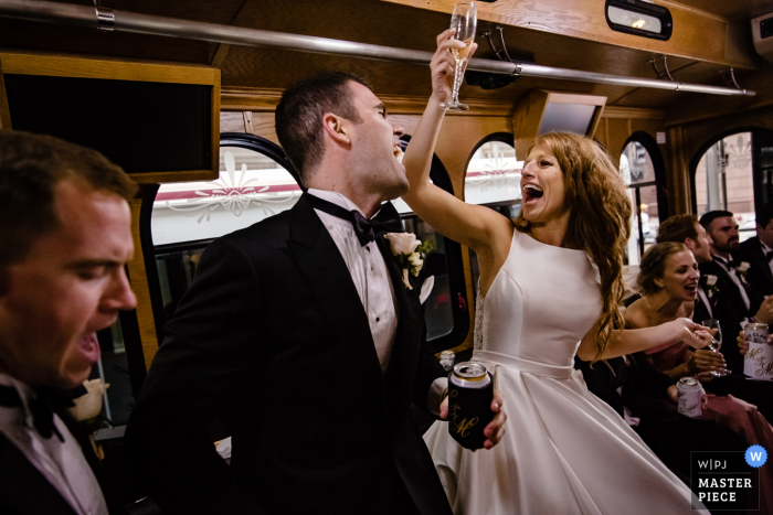 Photo by: <a href="https://www.wpja.com/contests/2019-v18/best-wedding-photographers/2567764">Milan Lazic - Chicago Illinois</a> Illinois bridal party in bus | Wedding picture of the bride and groom in the bus