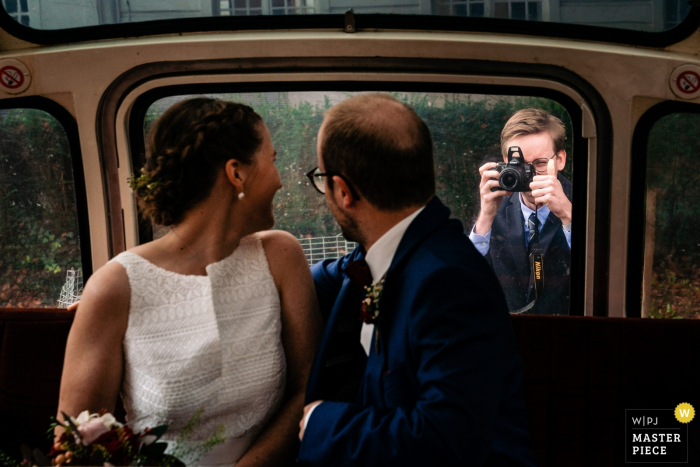 Photo by: <a href="https://www.wpja.com/contests/2019-v18/best-wedding-photographers/2567856">Yves Schepers - Bonheiden Antwerpen</a> Flanders Wedding Photography | Nephew of the bride, who's a photography fanatic, captures one last snapshot of the couple right before they take off to the reception and gives them a thumbs up. Do notice the pop-up flash!