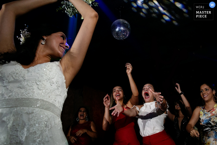 Photo by: <a href="https://www.wpja.com/contests/2019-v18/best-wedding-photographers/2567911">Claudia Amorim - Goiânia Goias</a> Brazil wedding photo of the bride tossing her bouquet at Bella Eventos