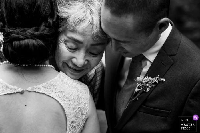 Photo by: <a href="https://www.wpja.com/contests/2019-v18/best-wedding-photographers/2567913">Brenda Bergreen - Evergreen Colorado</a> Sanborn County Park Wedding Photo - Bride and Groom greet grandmother after ceremony.