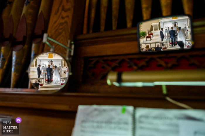 Photo by: <a href="https://www.wpja.com/contests/2019-v18/best-wedding-photographers/2567977">Ken Pak - Washington DC District Of Columbia</a> Charleston, SC wedding ceremony images | The organist's point of view of the ceremony with the bride and groom