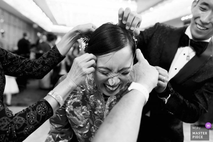 Photo by: <a href="https://www.wpja.com/contests/2019-v18/best-wedding-photographers/2567980">Ken Pak - Washington DC District Of Columbia</a> China Garden, Arlington, VA Wedding Pictures - The gifted necklaces got stuck on the bride