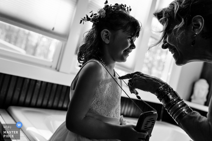 Photo by: <a href="https://www.wpja.com/contests/2019-v18/best-wedding-photographers/2568065">Kate Crabtree - Bangor Maine</a> Poland, Maine Wedding Photographer: A guest pokes the flower girl playfully at a Maine wedding.