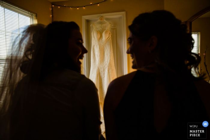 Photo by: <a href="https://www.wpja.com/contests/2019-v18/best-wedding-photographers/2568128">Miguel Gonzalez - Abington Pennsylvania</a> Philadelphia Ballroom Wedding Venue Pictures - Sisters share a moment before she puts on the dress.