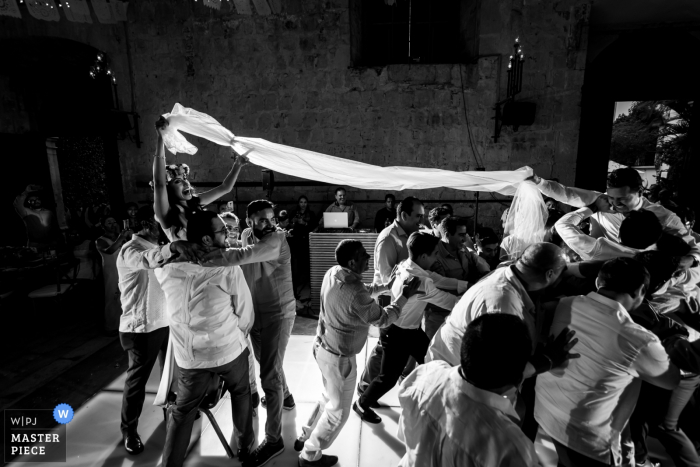 Photo by: <a href="https://www.wpja.com/contests/2019-v18/best-wedding-photographers/2568143">Douglas Favero - Oaxaca de Juárez Oaxaca</a> Wedding Venue Photography at the Hotel Quinta Real, Centro Histórico, Oaxaca, Mexico | The men are about to take down the groom, to the bride's anxious surprise, during a traditional king-of-the-hill type game late in the reception.