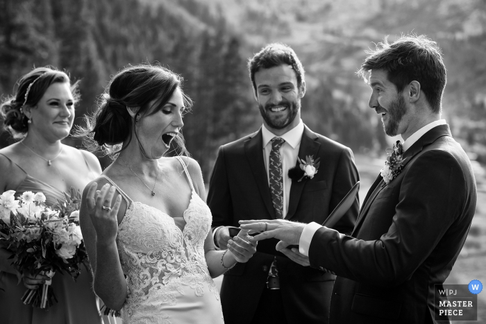 Resort at Squaw Creek, Squaw Valley, CA outdoor wedding photography | The bride & groom have fun with the ring exchange.