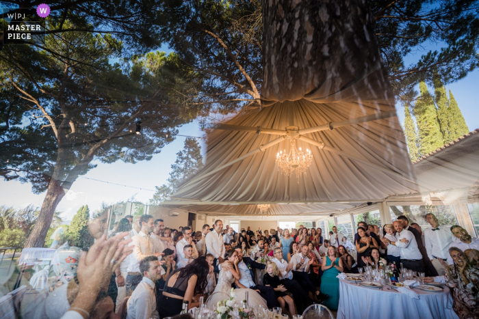 Photo by: <a href="https://www.wpja.com/contests/2019-v19/best-wedding-photographers/2568807">Andrea Sampoli - Siena Siena</a> Duomo di Lucignano d'Arezzo, Tuscany - Private Villa Trasimeno Lake - Photo of observing the reception hall and the emotional moment from outside the window with reflection of the glass