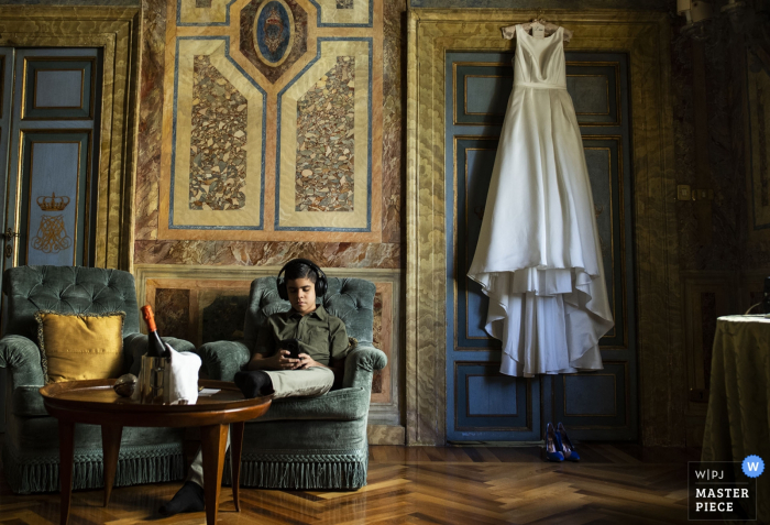 Photo by: <a href="https://www.wpja.com/contests/2019-v19/best-wedding-photographers/2568867">Pasquale Minniti - Reggio Calabria</a> Reggio Calabria bride before going to church with dress hanging over the door.