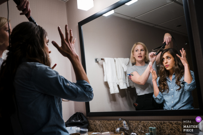 Photo by: <a href="https://www.wpja.com/contests/2019-v19/best-wedding-photographers/2569371">JD Land - Marlton New Jersey</a> New Jersey Hotel wedding photography of getting ready | Bride describing to her hair stylist what she is looking for