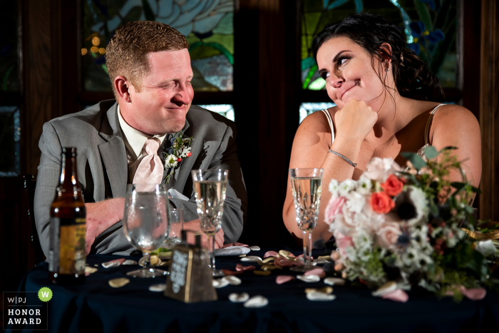 Bride and groom sharing a glance during toasts Lionsgate Event Center (Lafayette, CO) - Wedding Photojournalism at the Venue - Bride and groom sharing a glance during toasts.