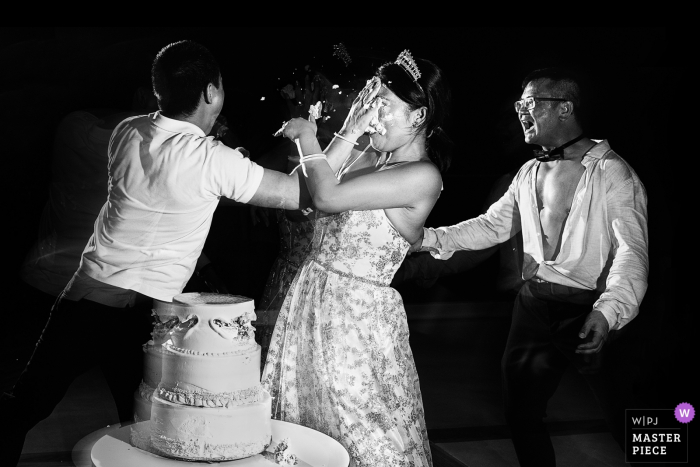 Photo by: <a href="https://www.wpja.com/contests/2019-v19/best-wedding-photographers/2569891">Momo Lynn - Beijing </a> Riu Palace Costa Mujeres Hotel After party wedding photo of the cake smash in the bride's face.