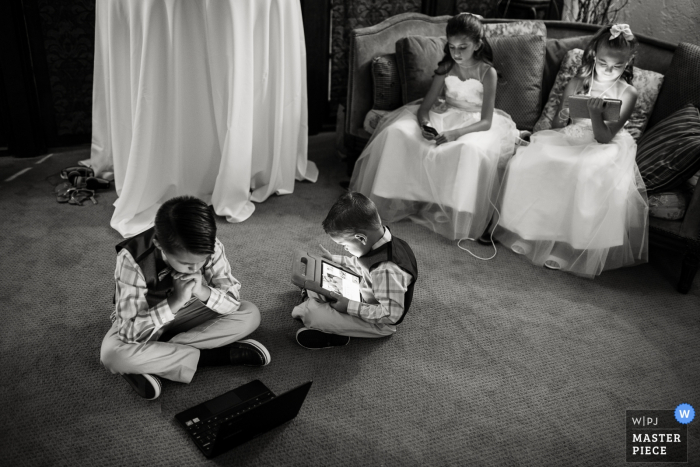 Photo by: <a href="https://www.wpja.com/contests/2019-v19/best-wedding-photographers/2569897">Carl Bower - Denver Colorado</a> The Villa Parker, Parker, Colorado wedding photography of kids | The ubiquitous screens.