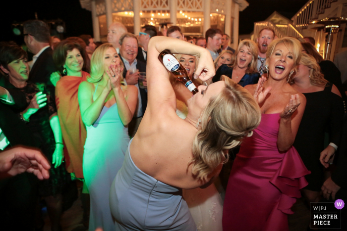 Watercolor Florida, reception wedding image contains: Bridesmaid showing off their muscles.