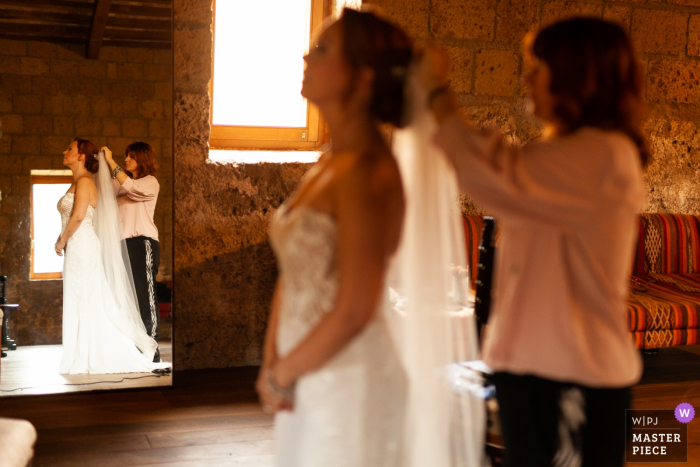 Photo by: <a href="https://www.wpja.com/contests/2019-v19/best-wedding-photographers/2570161">Zsofia Rebicek - Orvieto Terni</a> Abbazia di San Giusto wedding image of the bride getting ready with the help of her aunt