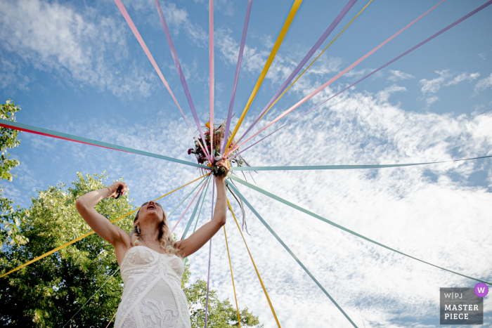 Photo by: <a href="https://www.wpja.com/contests/2019-v19/best-wedding-photographers/2570668">Simon Cassanas - Paris </a> paris bouquet ruban game - wedding day photography on nice, blue sky day