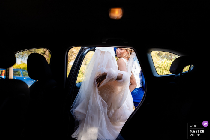 Photo by: <a href="https://www.wpja.com/contests/2019-v19/best-wedding-photographers/2570765">Lisa Pacor - Trieste Trieste</a> Zakynthos, Greece wedding photographer: Before the ceremony with the bride entering the car with her big dress