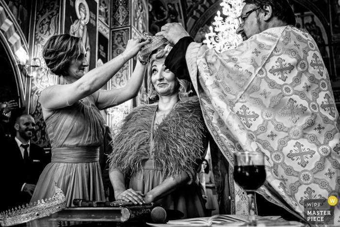 A Funny reaction of the bride during religious ceremony Sf. Antonie Maicaneasa (Church) Wedding Image Contains: A Funny reaction of the bride during religious ceremony