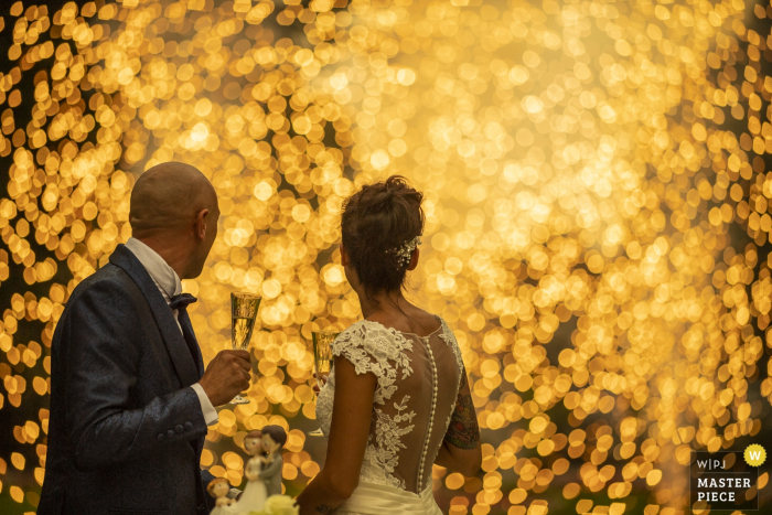 Photo by: <a href="https://www.wpja.com/contests/2019-v19/best-wedding-photographers/2570965">Luigi Rota - Lake Como Lecco</a> The bride and groom wrapped in the warm lights of fireworks at their reception, Villa Acquaroli Carvico
