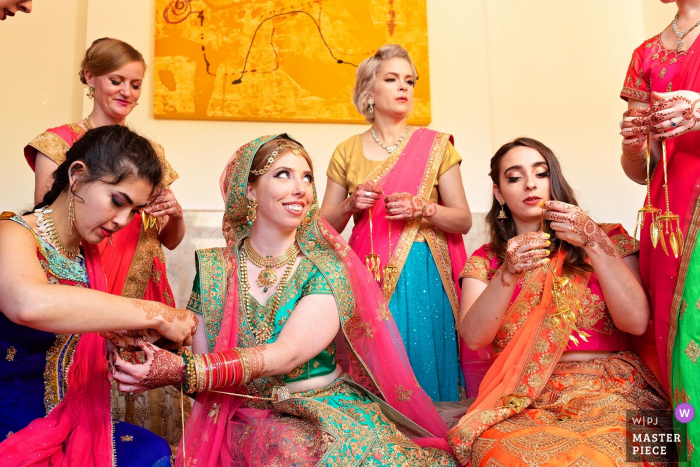 Photo by: <a href="https://www.wpja.com/contests/2019-v19/best-wedding-photographers/2570991">Candice C. Cusic - Chicago Illinois</a> Illinois Bride getting ready image contains: Indian pre-wedding ceremony of bride and parents, bridal party