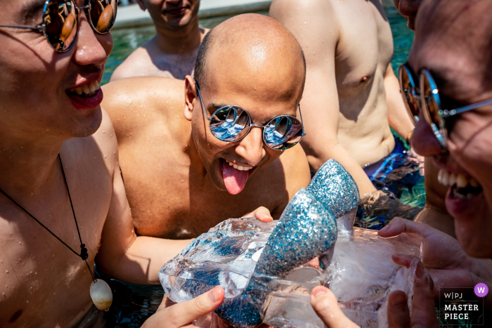 Photo by: <a href="https://www.wpja.com/contests/2019-v19/best-wedding-photographers/2571068">Will Tee - Taipei City </a> Taiwan Wedding Photographer at Sava Beach Villa - Image Contains: The groomsmen were trying to melt the ice inside the pool in order to get the bridal shoes at the bridal game time.