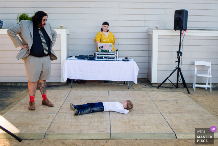 Photo by: <a href="https://www.wpja.com/contests/2019-v19/best-wedding-photographers/2571137">Siliang Wang - San Jose California</a> Stanford House at Oakland, CA Wedding Photo: The boy don't want get up on the dance floor and made funny faces with his dad