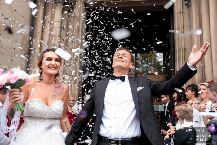 The newlyweds come out of the church after the wedding ceremony at the Temple de l'Eglise