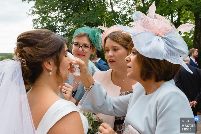 Cérémonie du mariage en Île-de-France: la maman de la mariée et les demoiselles d'honneur sèchent les larmes de la mariée