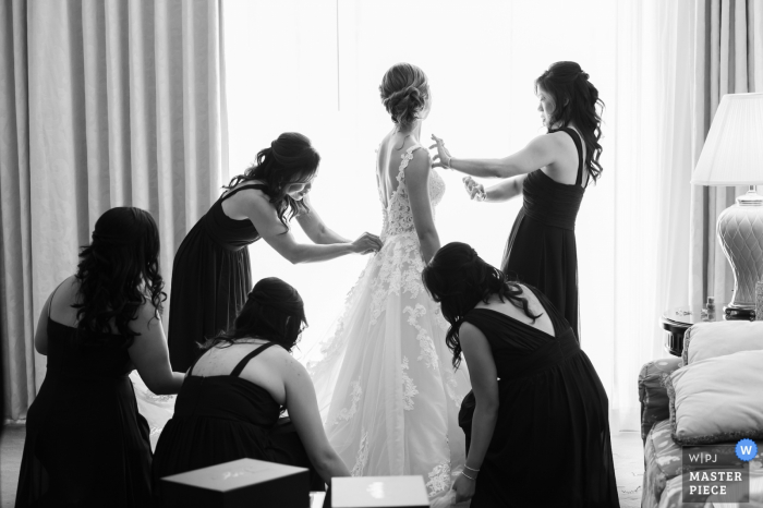 Florida Wedding Photographer: At the hotel.	The bride getting ready with her bridesmaids