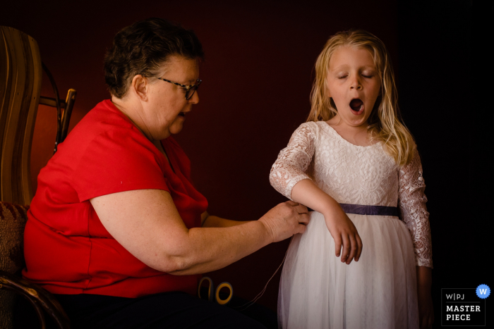 Photo by: <a href="https://www.wpja.com/contests/2019-v20/best-wedding-photographers/2572481">David Clumpner - Missoula Montana</a> Big Sky, Montana getting ready image of a flower girl getting alterations