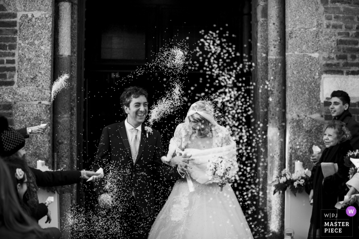 Bride and Groom exit the church Chiesa Provincia di Milano | Bride and Groom exit the church and are greeted with a shower of rice from their guests.