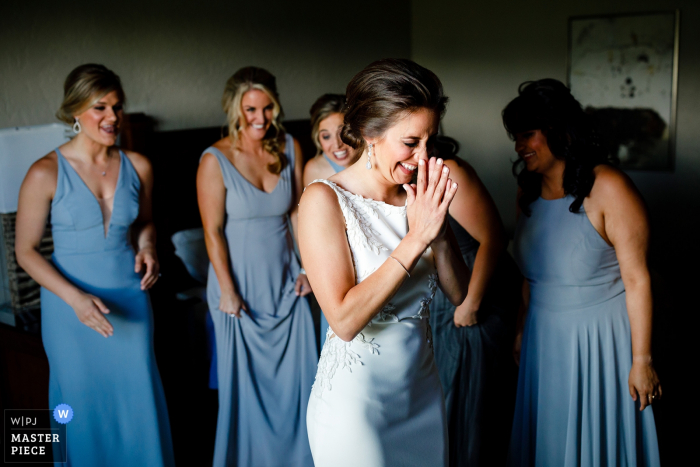 Photo by: <a href="https://www.wpja.com/contests/2019-v20/best-wedding-photographers/2574271">Trent Gillespie - Silverthorne Colorado</a> Ritz-Carlton Bachelor Gulch wedding venue photos | The bride excited about how she looks in her wedding dress with her bridesmaids support.