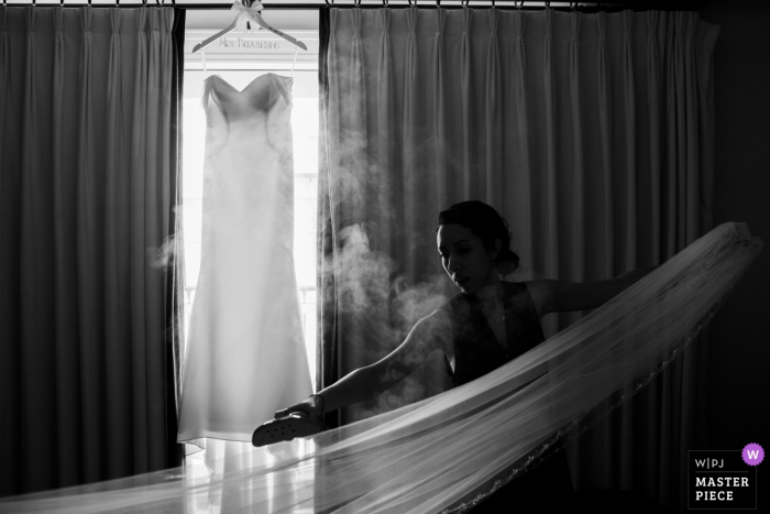Photo by: <a href="https://www.wpja.com/contests/2019-v20/best-wedding-photographers/2574934">Siliang Wang - San Jose California</a> palo alto garden court hotel- Bridesmaids are ironing the veil