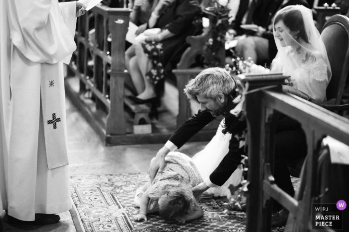 Eglise de Tiffauges Kerk Trouwfoto's | De dochter van de bruid en bruidegom valt gewoon op de grond