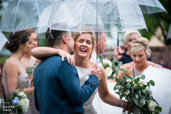 The groom whispers a greeting to the bride Photography of the wedding ceremony at the bride's home, Gartocharn, Stirlingshire | The groom whispers a greeting to the bride as she arrives at the alter
