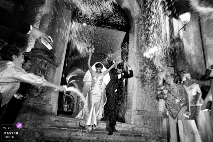 Cattedrale di Gerace, Gerace, Reggio Calabria Wedding Photos | Rice toss as the bride and groom leave the church at night.