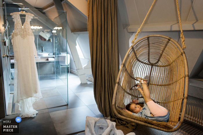 Photo by: <a href="https://www.wpja.com/contests/2019-v20/best-wedding-photographers/2576137">Jess van Ruiven - Heerhugowaard Noord Holland</a> Haarlem Staatshotel, getting ready bride suite photography | getting ready wedding dress bridesmaid in egg chair