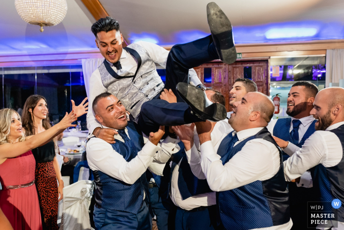 Mirador de Cuatro Vientos wedding venue photography | Groomsmen takes the groom in the air