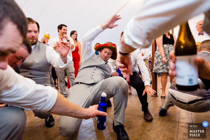 Photo by: <a href="https://www.wpja.com/contests/2019-v20/best-wedding-photographers/2576315">Kate Crabtree - Bangor Maine</a> French's Point, Stockton Springs Maine wedding venue photos | A groomsman dances at a Maine wedding.